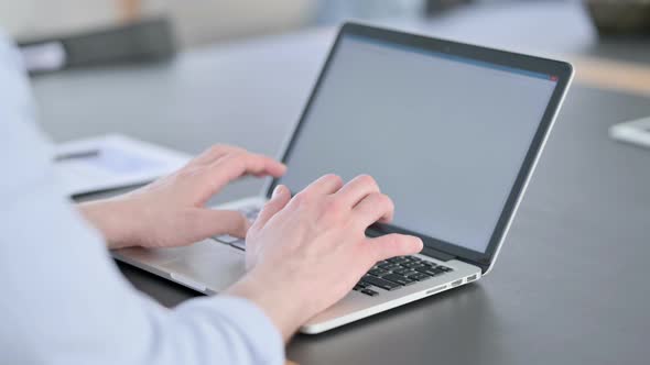 Man in Glasses Using Laptop with White Screen