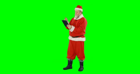 Santa claus using digital tablet 4k