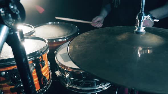 Drumsticks Are Hitting Metal Cymbals and Drums in a Close Up