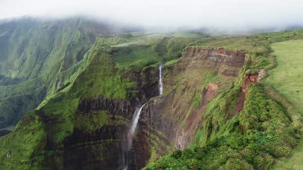 Amazing Natural Beauty with Lush Vegetation and Streaming Waterfall