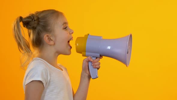 Little Female Child Shouting in Megaphone Trying to Be Heard by Parents, Protest