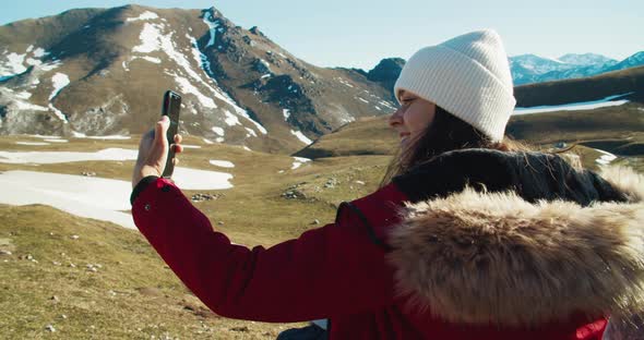 Portrait of Young Adult Woman Taking Selfie on Mountains