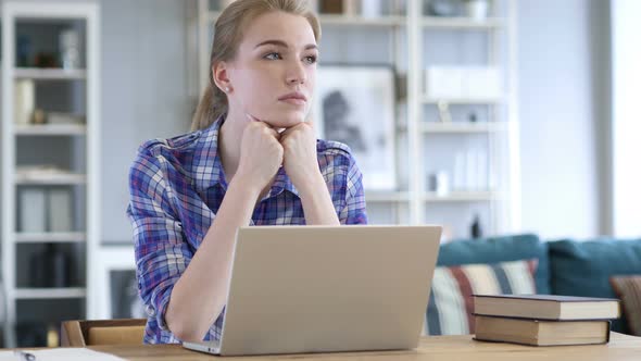 Pensive Woman Thinking while Sitting in Casual Office