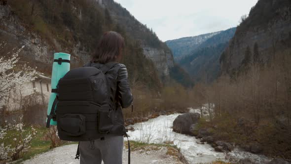 Lady Hiker with Backpack Looking on Hills and Mountain River Lake, Girl Enjoying Nature Panoramic