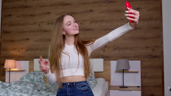 Smiling Cute Vlogger Girl Looking at Mobile Make Video Call Shooting Vlog Taking Selfie at Home