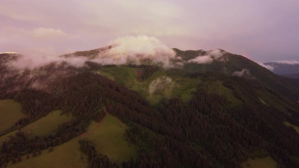 Clouds Form Over the Forest Hilly Landscape Shortly After the Rain at Dusk in the Golden Hour