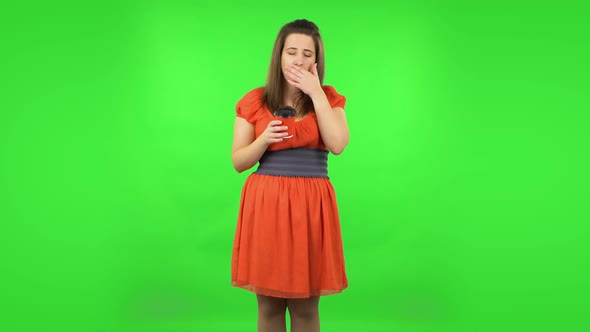 Cute Girl Is Drinking Unpalatable Coffee and Is Disgusted. Green Screen