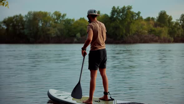 Man Swim Surfing Boat Fitness Workout With Oar.Sup Board.Standup Puddle Board.Sup Surfing