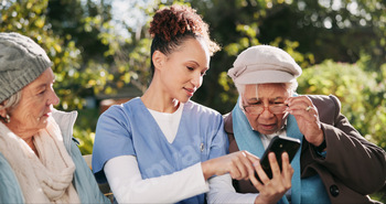 App, phone and nurse with old people in park together for assisted living, communication or healthc