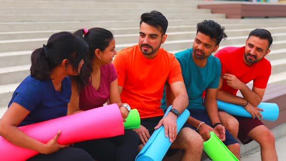 Four Indian People Talking Outdoors in Sport Wear Morning Time Urban