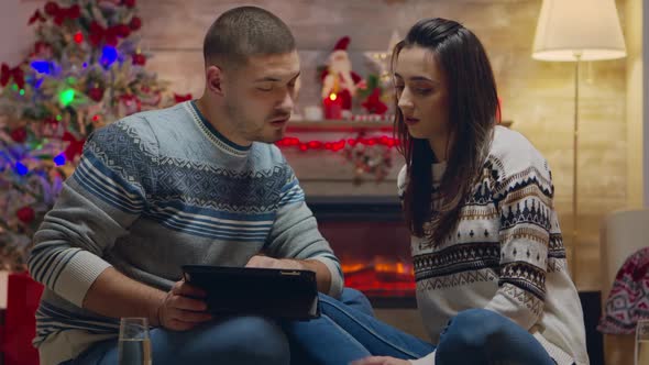 Caucasian Couple Doing Online Shopping on Tablet Computer