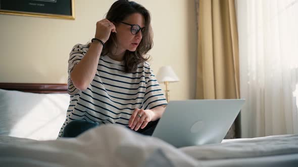 A Young Woman Freelancer Taking a Video Conference Meeting on Her Laptop