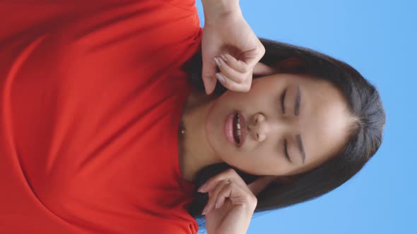 Young Woman Plugging Hear Ears with Fingers