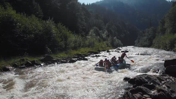 People in Inflatable Boat Rafting By Rapid River