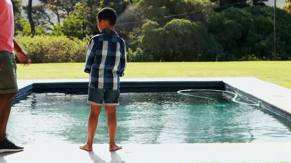 Father and son walking near poolside