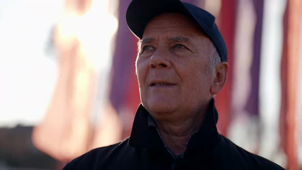 Portrait of Old Man Outdoor in Autumn Day Senior Man in Cap is Looking Around