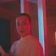 Young woman holding VR goggles in red and blue neon light - VideoHive Item for Sale