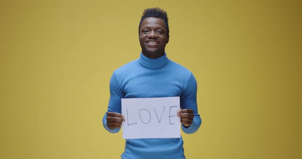 Young Man Holding Sign