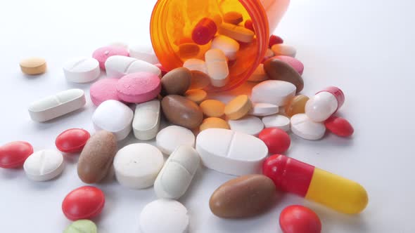 Close Up of Colorful Pills Spilling on White Background 