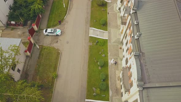 Newlywed Couple Hugs Near Building on Street Aerial View