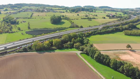 freight train with containers passing through landscape