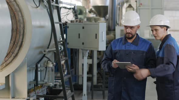  Busy Factory Workers with Tablet