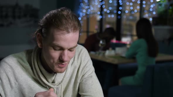 Portrait of Eating and Actively Talking Young Man