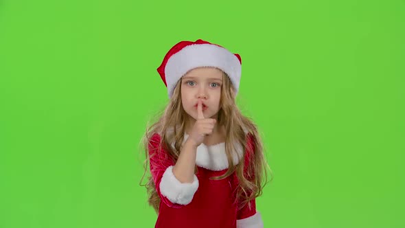 Child Girl of the Assistant Santa Claus Say Quietly To Their Elves. Green Screen