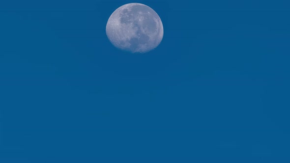 Full moon is moving across light clear blue sky background Time Lapse,Amazing moon High quality