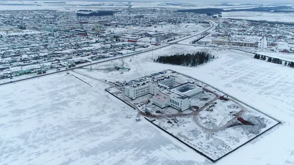 Construction Site of Industrial Buildings in Snowy Field