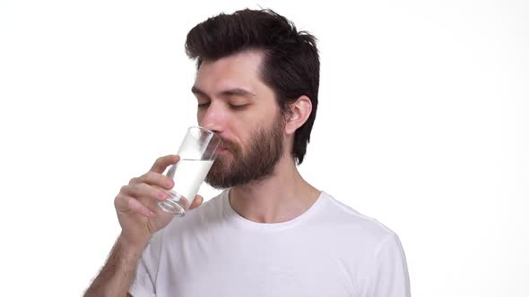 Young Man Drinking Water From a Glass Smiling