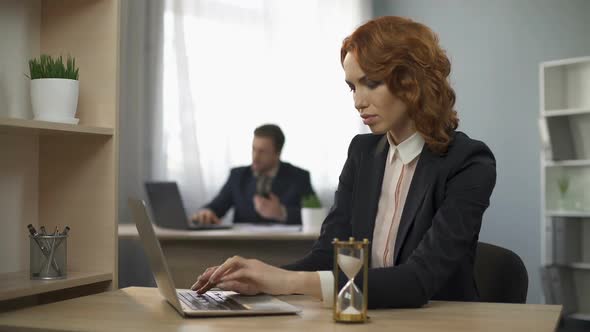 Female Company Worker Typing on Laptop, Hourglass Trickling, Devotion to Work