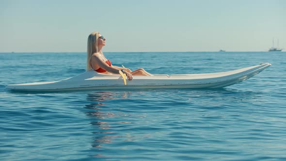 Girl In Kayak Summer Trip. Woman Exploring Calm Sea By Canoe On Holiday Vacation Weekend.