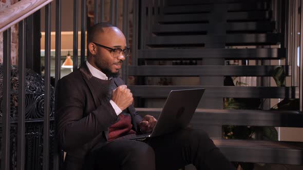 Black Businessman Using Laptop for Analyzing Data Stock Market Stock Exchange Trading Online