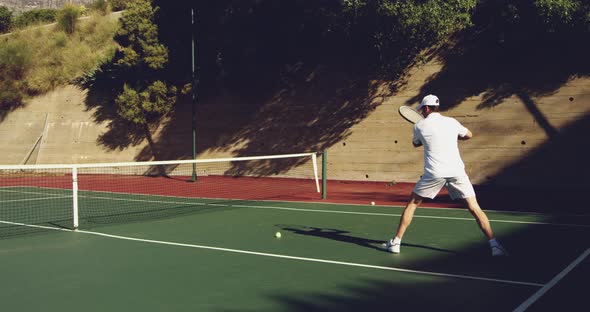 Man playing tennis on a sunny day