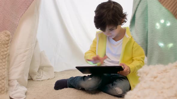 Little Boy with Tablet Pc in Kids Tent at Home