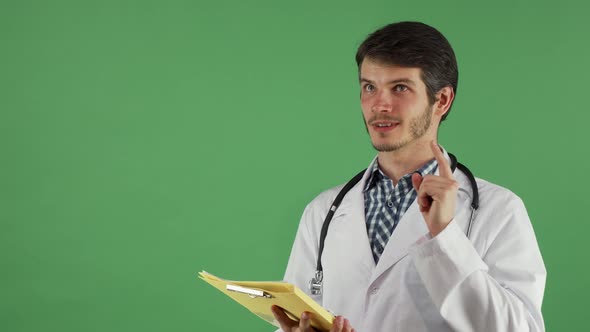 Handsome Male Doctor Having an Idea While Examining Documents