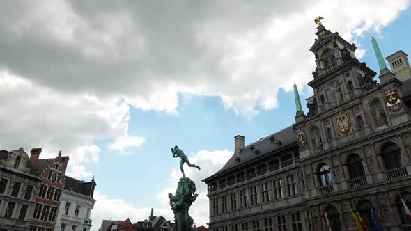 Dark clouds above the city of Antwerp, Belgium. Grote Markt with Town Hall and Brabo Fountain - Time