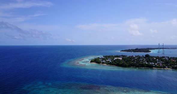 Beautiful fly over clean view of a sunshine white sandy paradise beach and turquoise sea background 