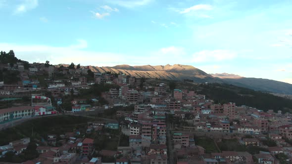 4k daytime aerial drone view over the hill and houses of Alto Los Incas neighbourhood in Cusco, Peru