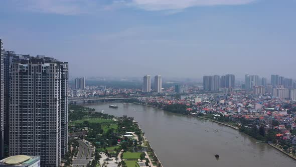 Aerial view of Saigon river flying past new apartment buildings in Binh Thanh towards Thao Dien on a