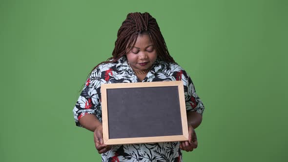 Overweight Beautiful African Woman Against Green Background