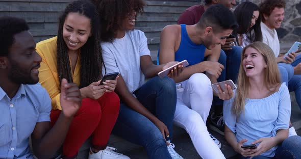 Happy diverse people using mobile phones outdoor