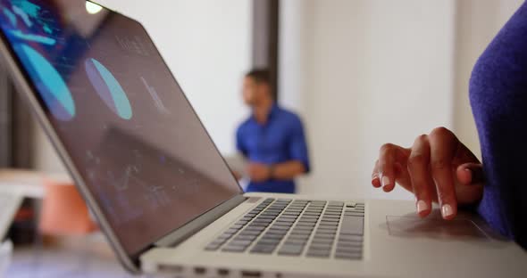 Businesswoman using laptop in a modern office 4k