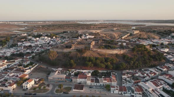 Pan left shot of hilltop fortification Castelo de Castro Marim Castle and fort São Sebastião.