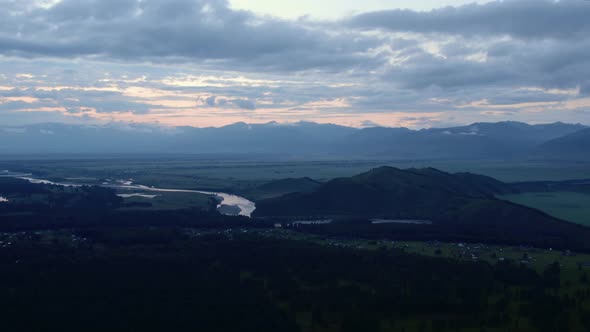 Aerial view from a drone on majestic valley in Altai under sunset sky