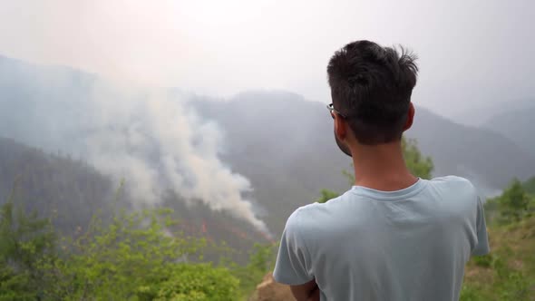 Indian man watching Forest Fire