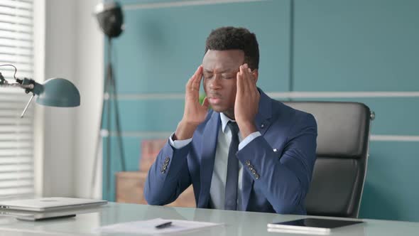 Upset African Businessman Feeling Worried While Sitting in Office