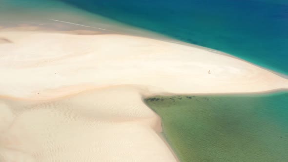 Aerial View of a Man Exercising on the Edge of the Ocean Free of Waves