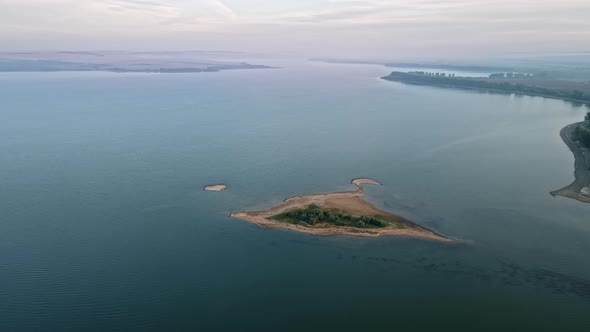 Aerial drone view of the Duruitoarea natural reservation in Moldova. River with small island, fog in